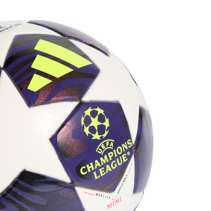 Mini soccer ball close-up featuring Champions League badge, neon yellow Adidas icon, purple panels