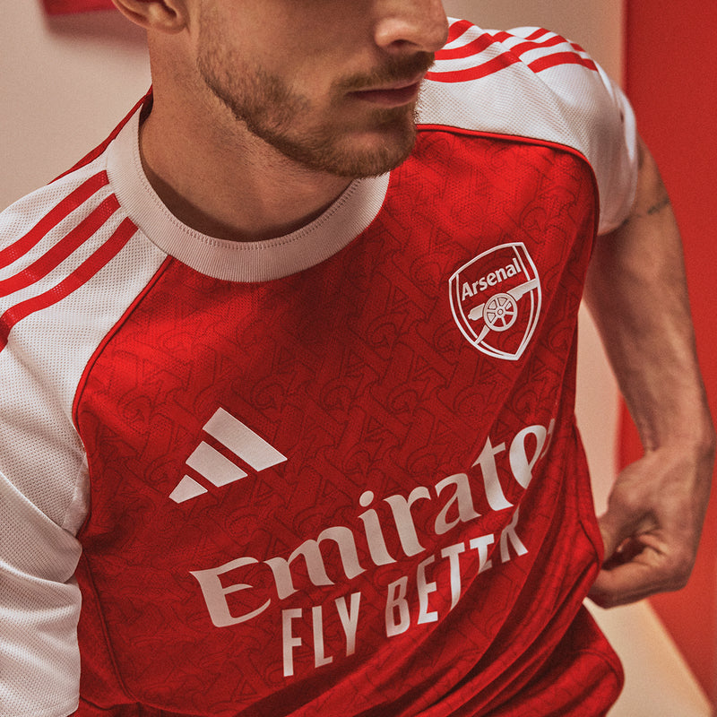 Arsenal authentic 3rd jersey chest close-up: Emirates Fly Better and club crest on red
