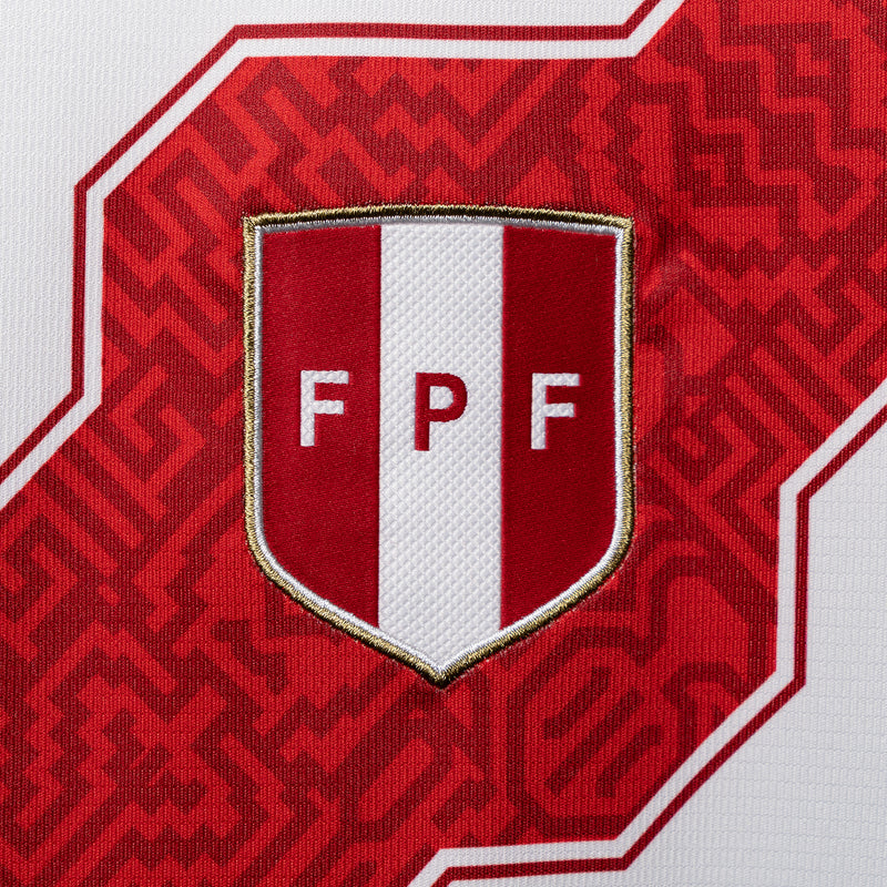 FPF crest patch on red-and-white soccer jersey with metallic edge trim