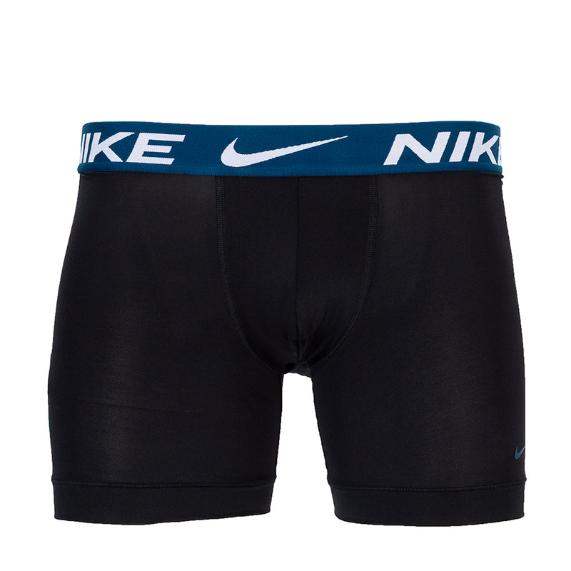 Black boxer briefs with blue waistband and NIKE logo print, mid-thigh length