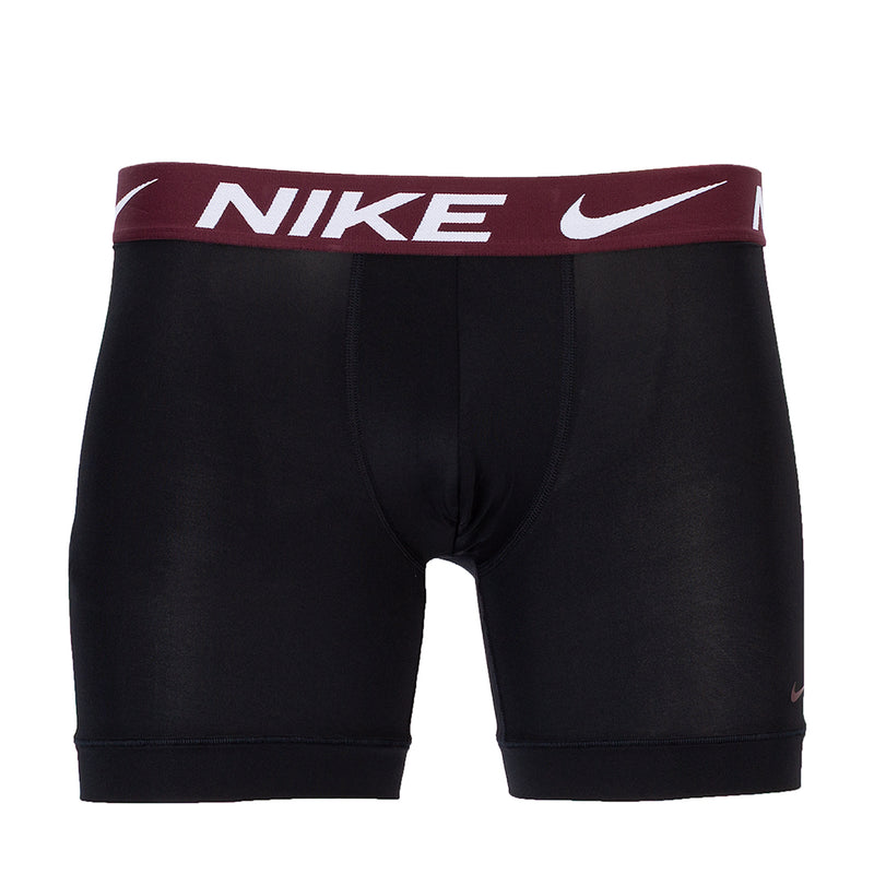 Black boxer briefs with burgundy waistband and NIKE logo print, mid-thigh length