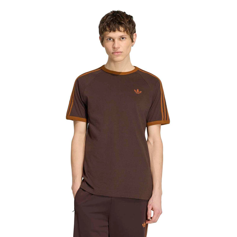 Men's brown T-shirt with orange collar trim and small chest trefoil logo