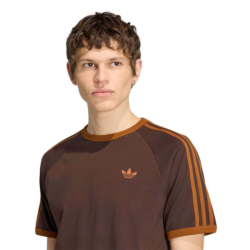 Men's brown T-shirt with orange crew neck and chest trefoil logo