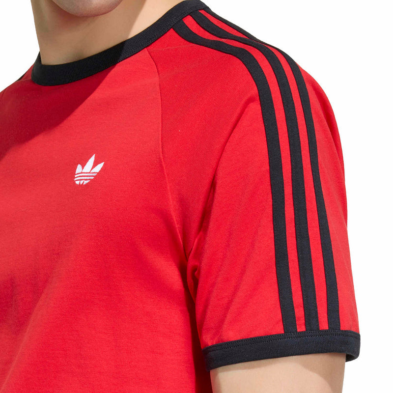 Men's red adidas T-shirt sleeve close-up with black 3-stripe band