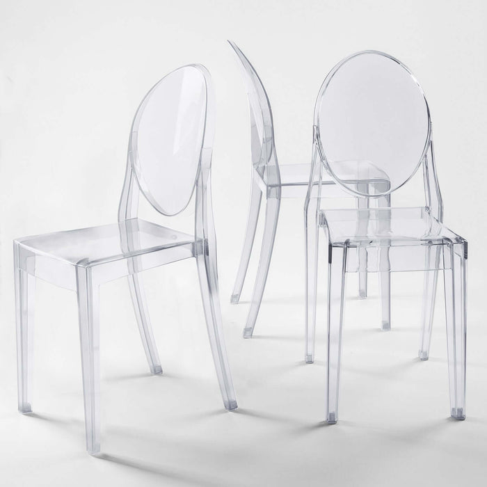 Clear acrylic chairs in modern design against a plain backdrop