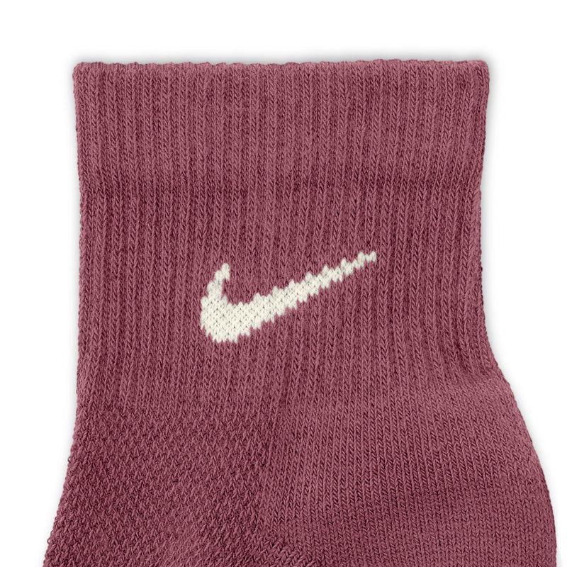 Maroon knit quarter sock with white Nike swoosh logo on the foot