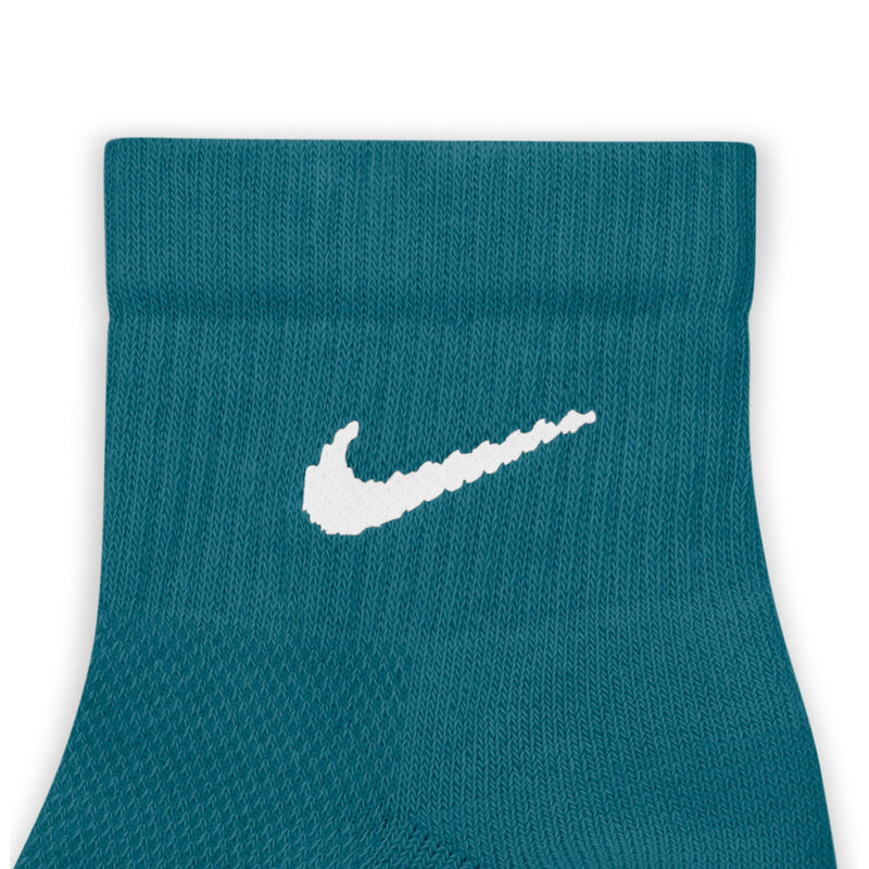 Teal quarter sock close-up with white Nike swoosh logo on front