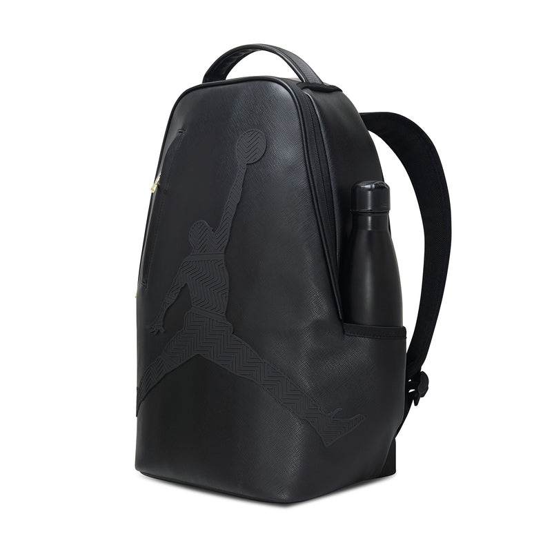 Black backpack with side pocket and attached water bottle, gold zipper detail
