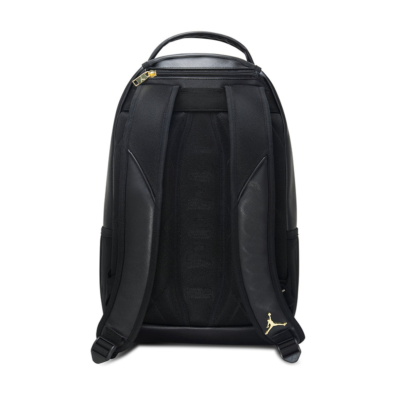 Black backpack back view with padded shoulder straps and gold Jumpman accents