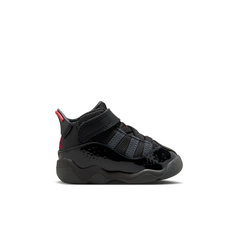 Black toddler sneakers with red accents, hook-and-loop straps, and chunky gray sole.