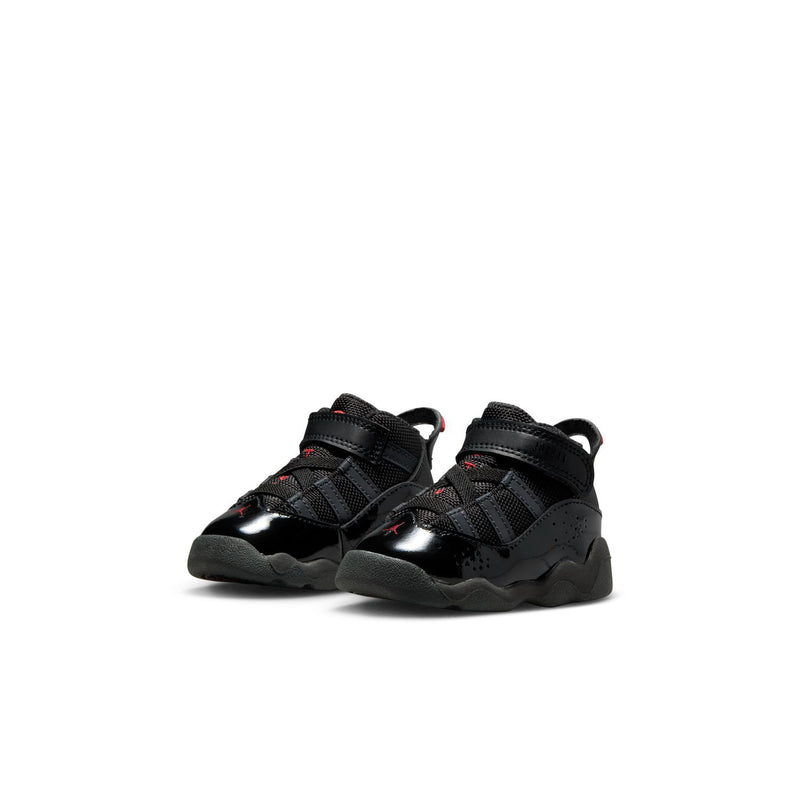 Pair of black toddler sneakers with red accents, side straps, and grippy gray outsole.