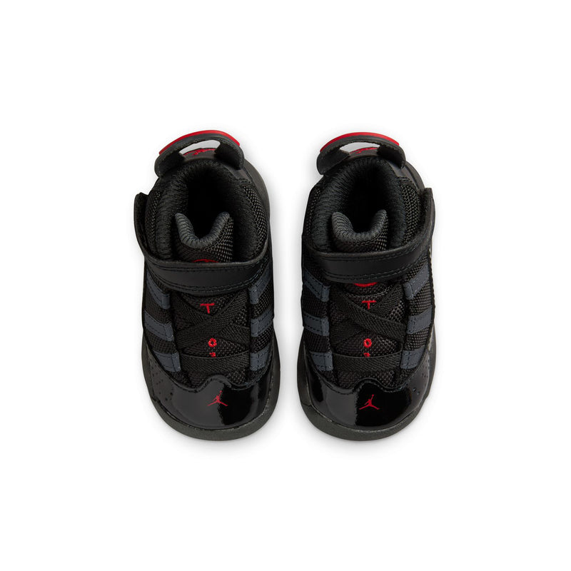Black toddler sneakers showing padded collar and heel, with red interior logo accents.