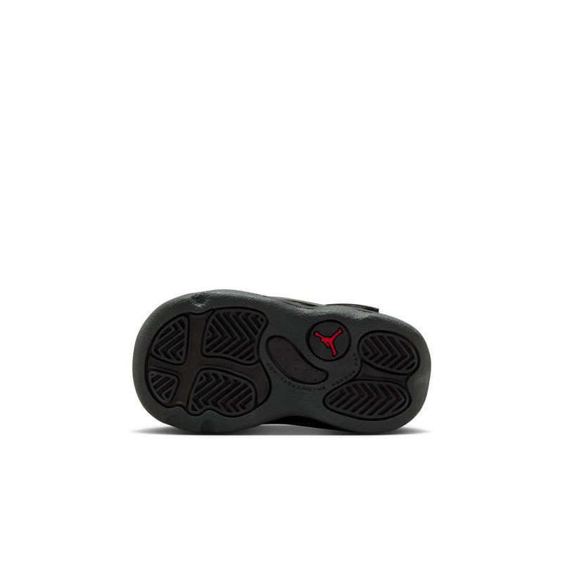 Black toddler sneaker outsole with tread pattern and red Jordan logo on heel.