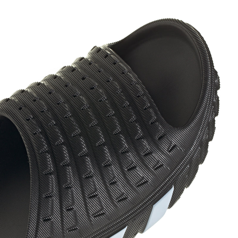 Close-up of men's black slide sandal upper with embossed texture and open toe