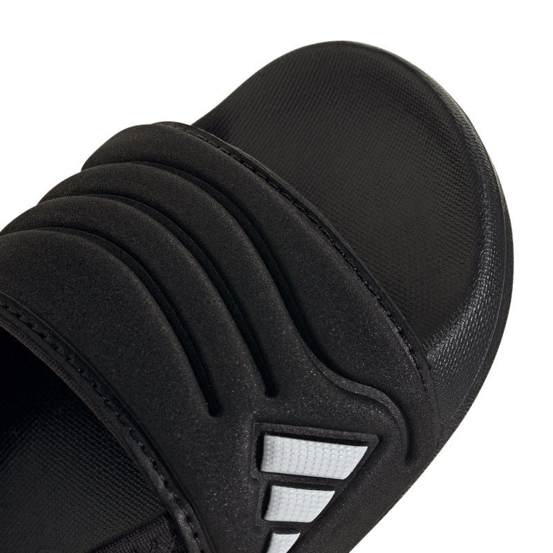 Close-up of black toddler slide sandal strap with white triple stripes logo