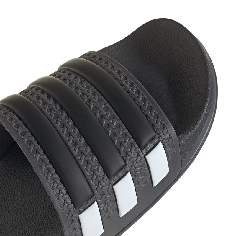 Black slide sandal strap with textured bands and three white stripe inserts