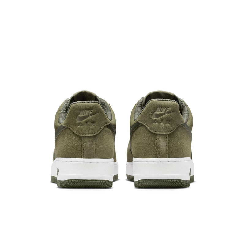 Men's low-top sneakers with olive suede heels, white midsole, green tread, lace-up detail.