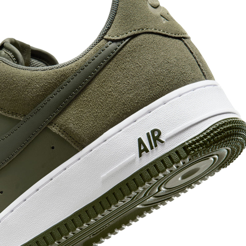 Sneaker midsole and outsole close-up: olive suede, white 'AIR' branding, green rubber tread.