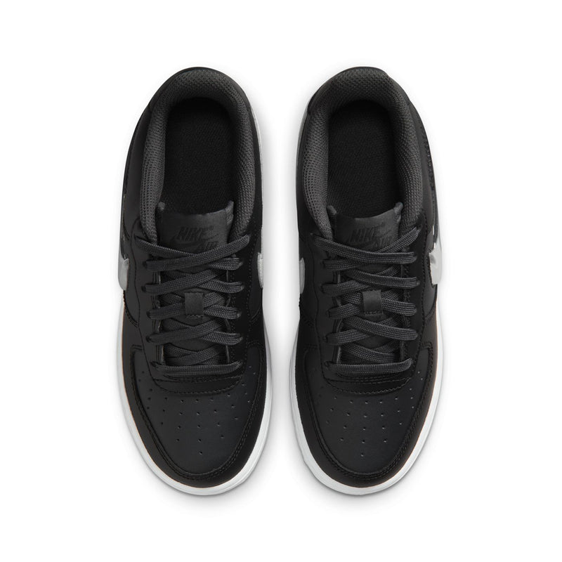Youth low-top sneakers viewed from above; black uppers with black laces and white edge