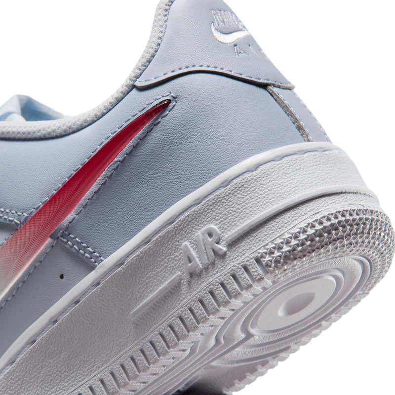 Close-up of youth sneaker side and midsole, showing red accent and 'AIR' detail