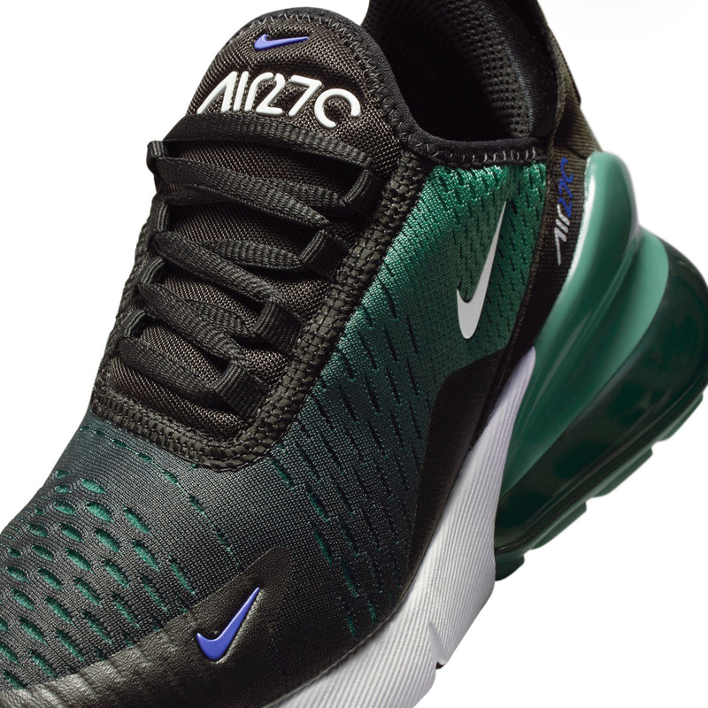 Youth sneaker close-up: black laces with deep green knit panel and white Swoosh