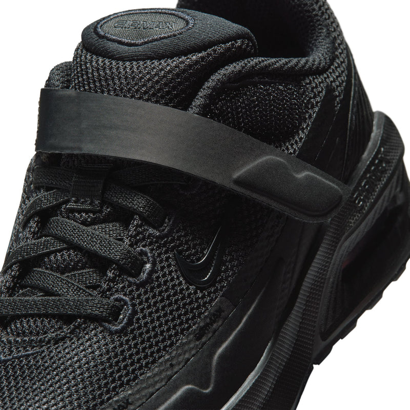 Kids black sneaker close-up: textured mesh upper, lace panel, and heel strap