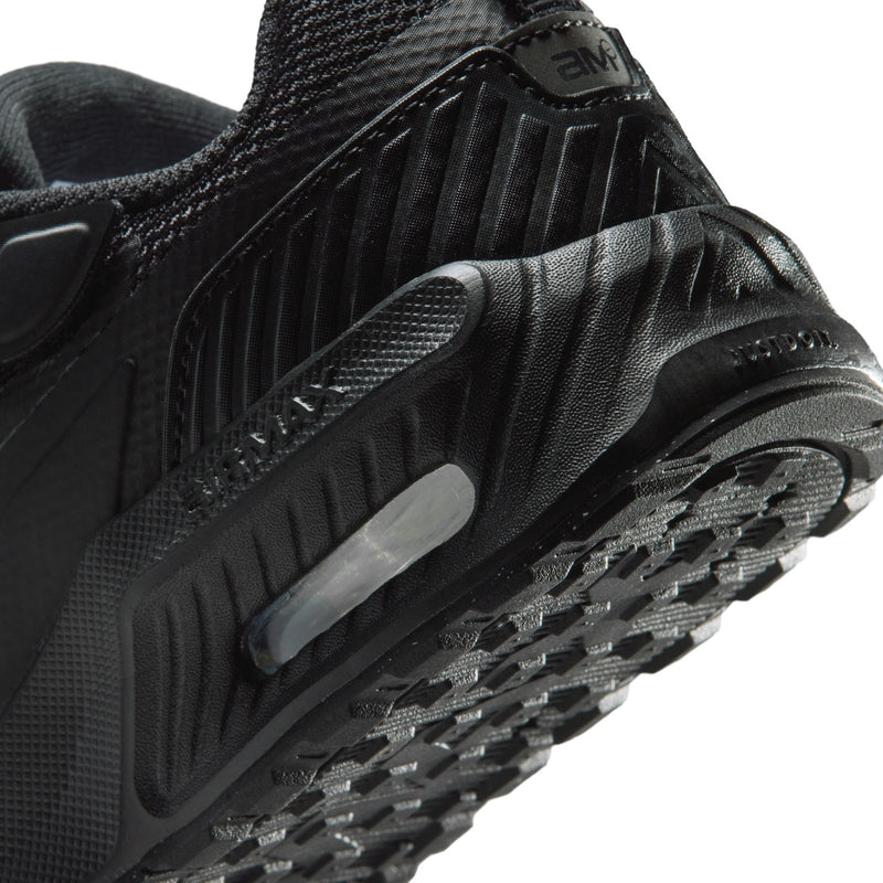 Kids black sneaker close-up: Nike swoosh, visible air unit window, tread pods