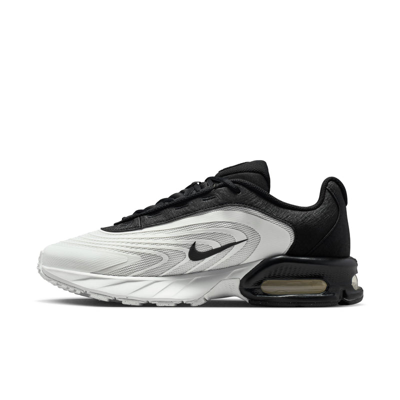 Men's running shoes side profile, black and white design with Air Max heel unit