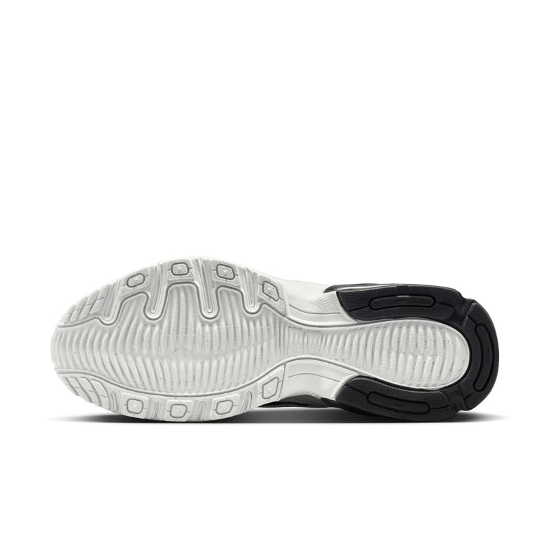 Shoe outsole view with textured tread and black heel insert