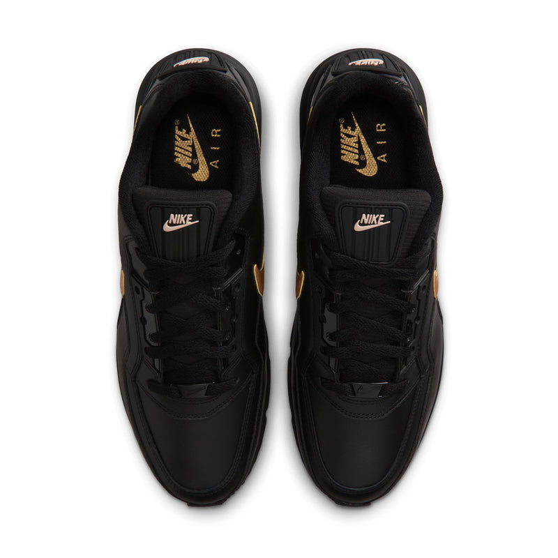 Pair of black sneakers shown from above, black laces with NIKE and gold tongue accents