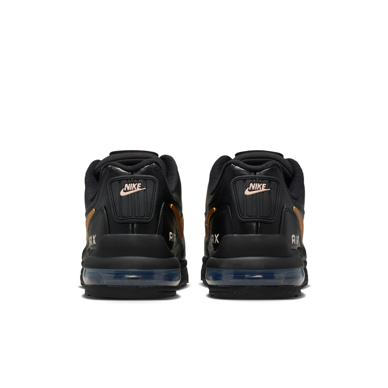 Men's black sneakers rear view with NIKE heel tabs and blue-tinted air cushioning