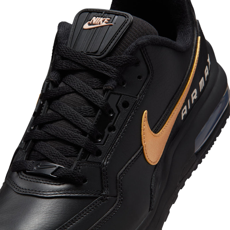 Close-up of men's black sneaker quarter with gold Swoosh and AIR MAX side badge