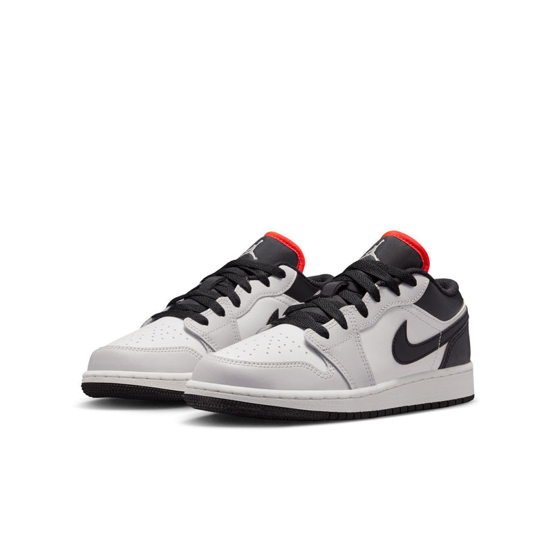 Pair of youth low-top sneakers, white uppers with black overlays and red collar lining