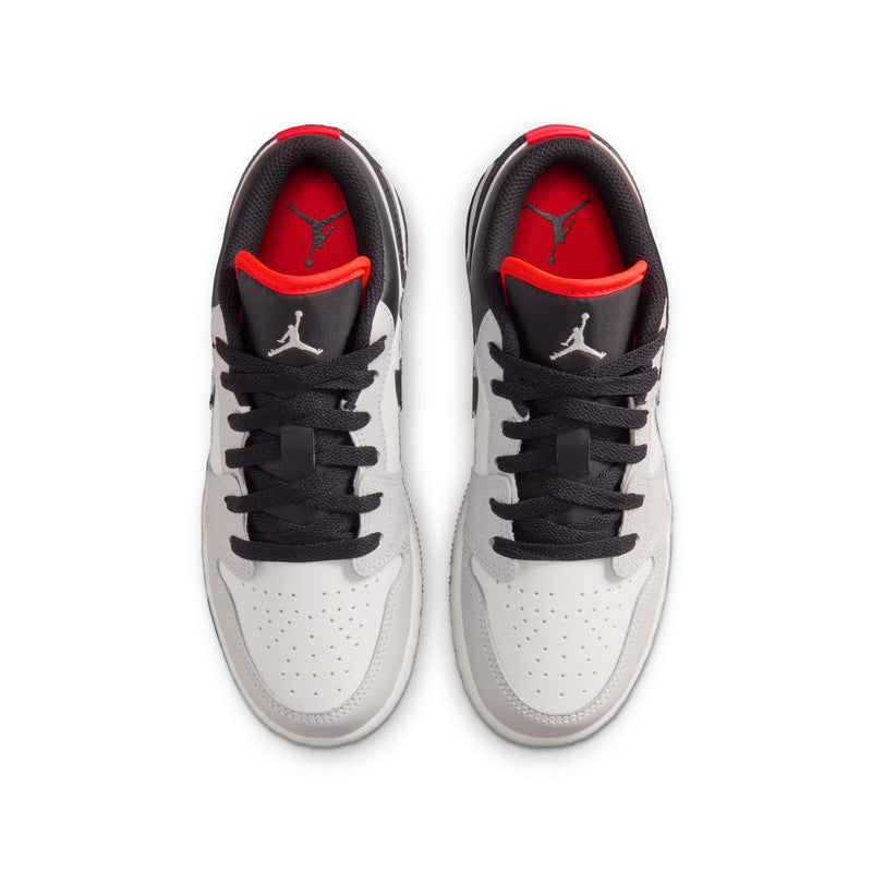 Youth sneakers with black laces and red-lined tongue, white toe cap