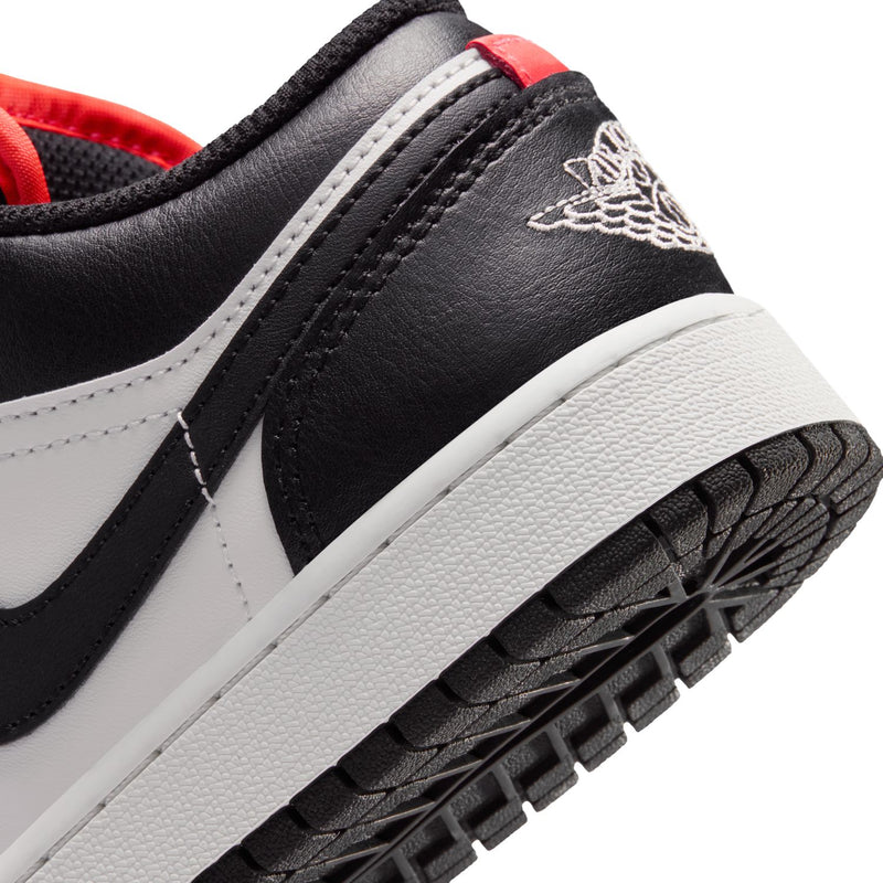 Youth sneaker close-up: black leather side, white midsole, black outsole tread