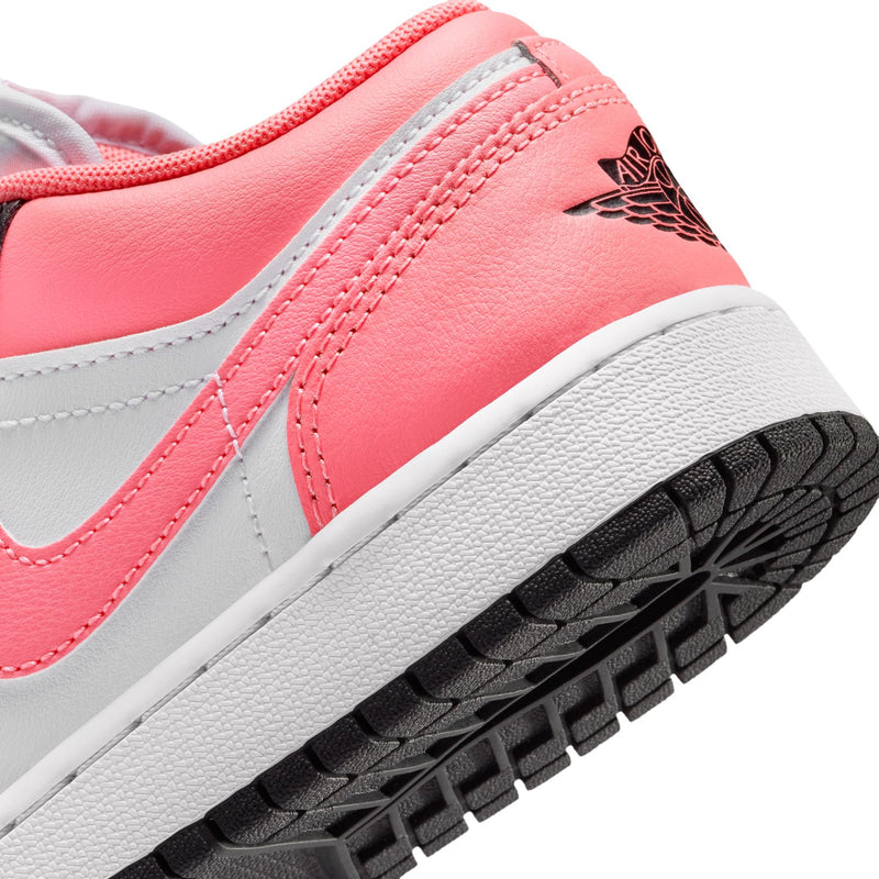 Close-up of youth sneaker side with pink leather, white midsole, and black outsole tread