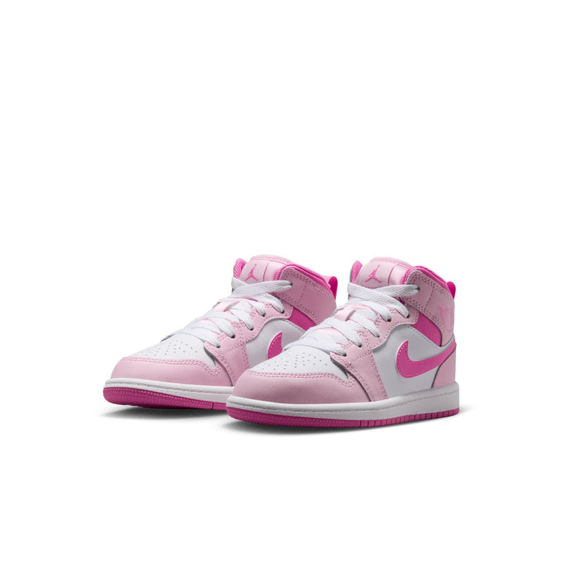 Pair of kids' mid-top sneakers, pink and white with lace-up closure
