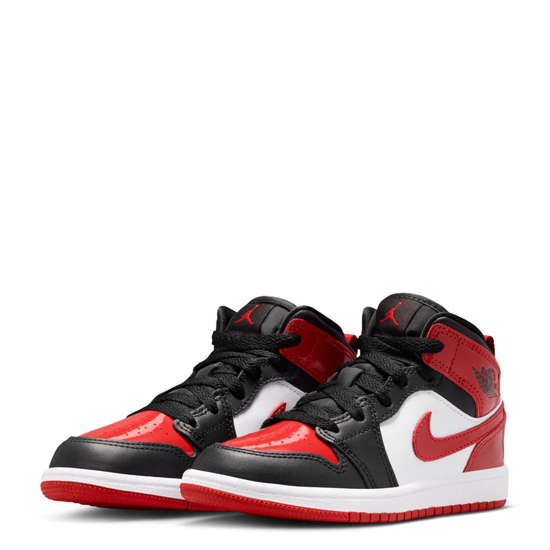 Pair of kids mid-top sneakers in red, white, and black with low-profile outsole.