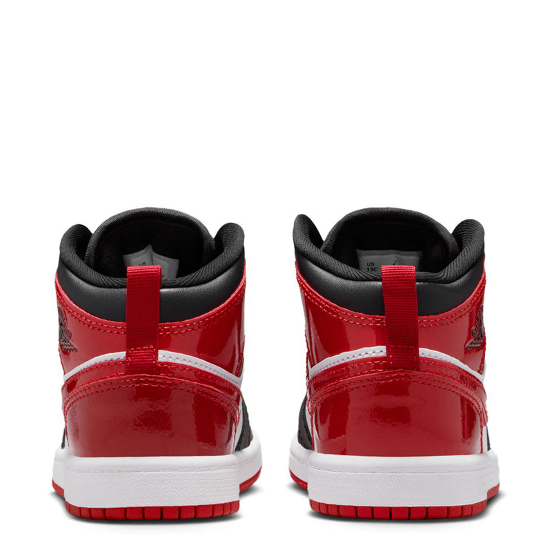 Kids mid-top sneakers in red and white with black heel panels and lace collar.