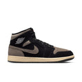 Mid-top sneakers in black and olive grey with Nike swoosh and beige outsole trim.