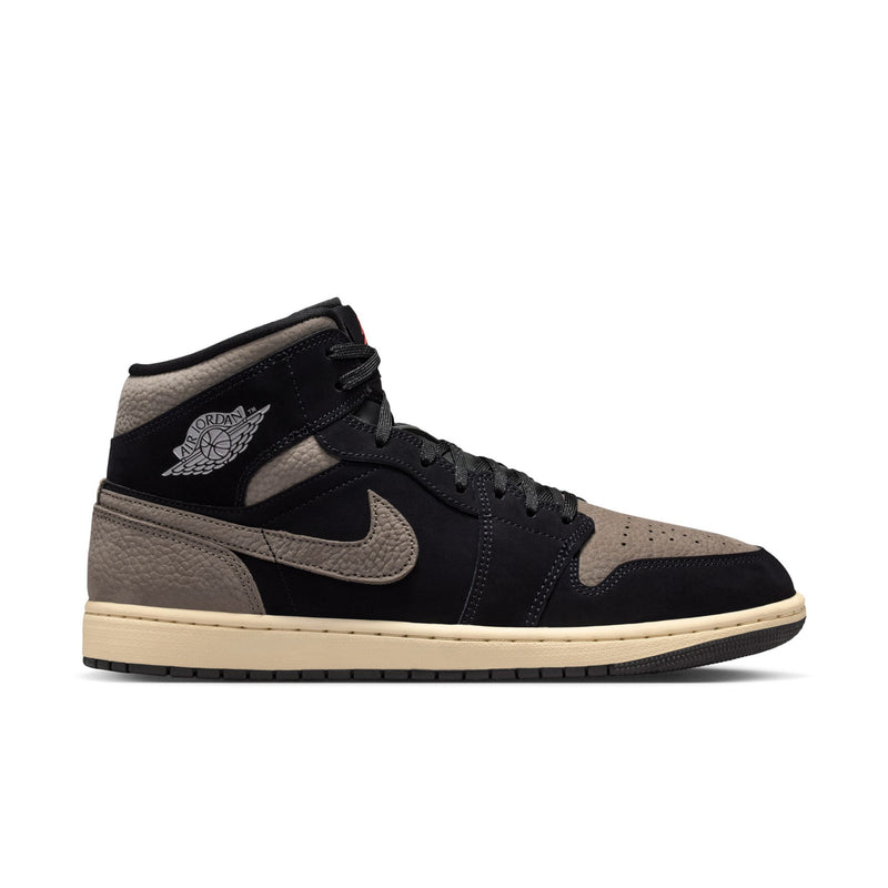 Mid-top sneakers in black and olive grey with Nike swoosh and beige outsole trim.