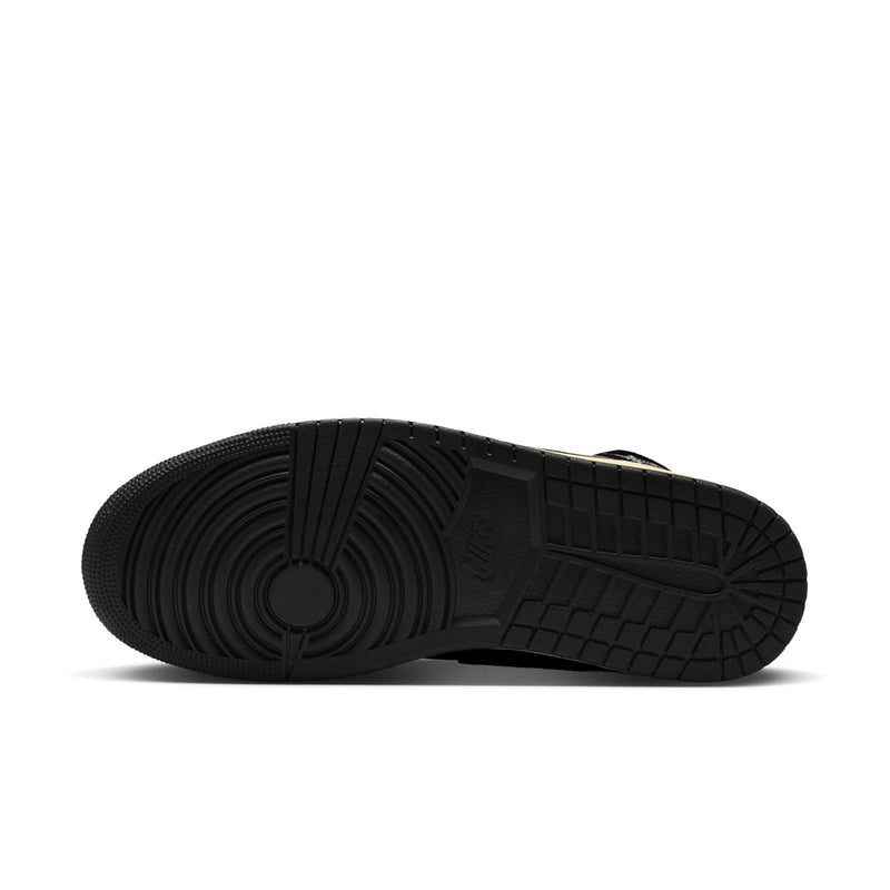 Black rubber outsole with textured tread pattern on the mid-top sneakers.