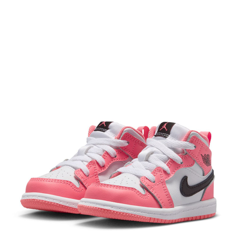 Pair of pink and white toddler mid-top sneakers with black swoosh and white lace-up design