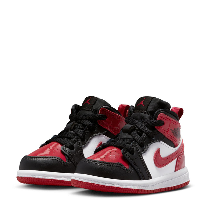 Pair of toddler mid-top sneakers, black and red with white overlays and red Swoosh