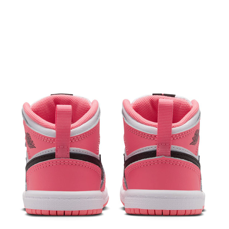 Back view of pink and white toddler mid-top sneakers with black collar trim and lace tabs