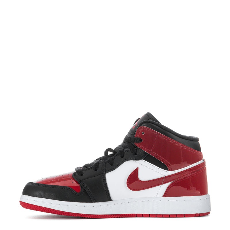 Youth mid-top sneakers, red and white panels with black collar and swoosh.