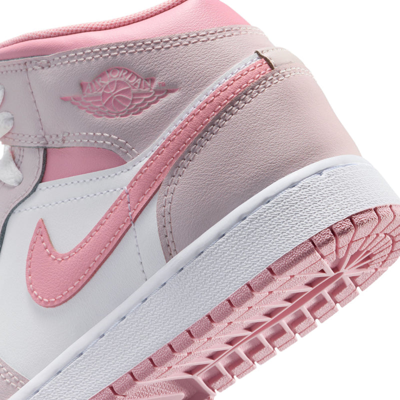 Close-up of youth high-top sneaker: pink eyestay, Swoosh panel, and textured outsole