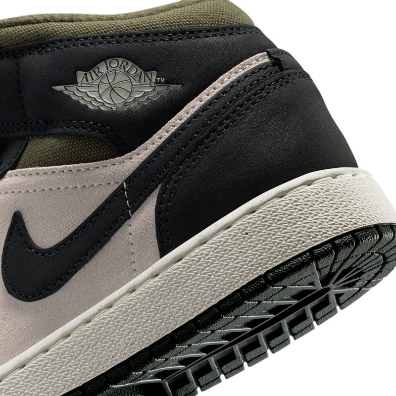 Youth mid-top sneaker detail, black swoosh on off-white panel with Air Jordan wing logo