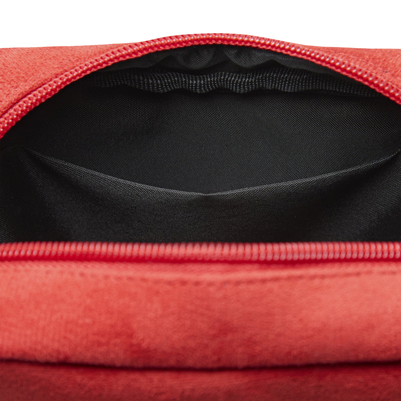 Open zip-top interior of red crossbody bag with black lining and fabric texture