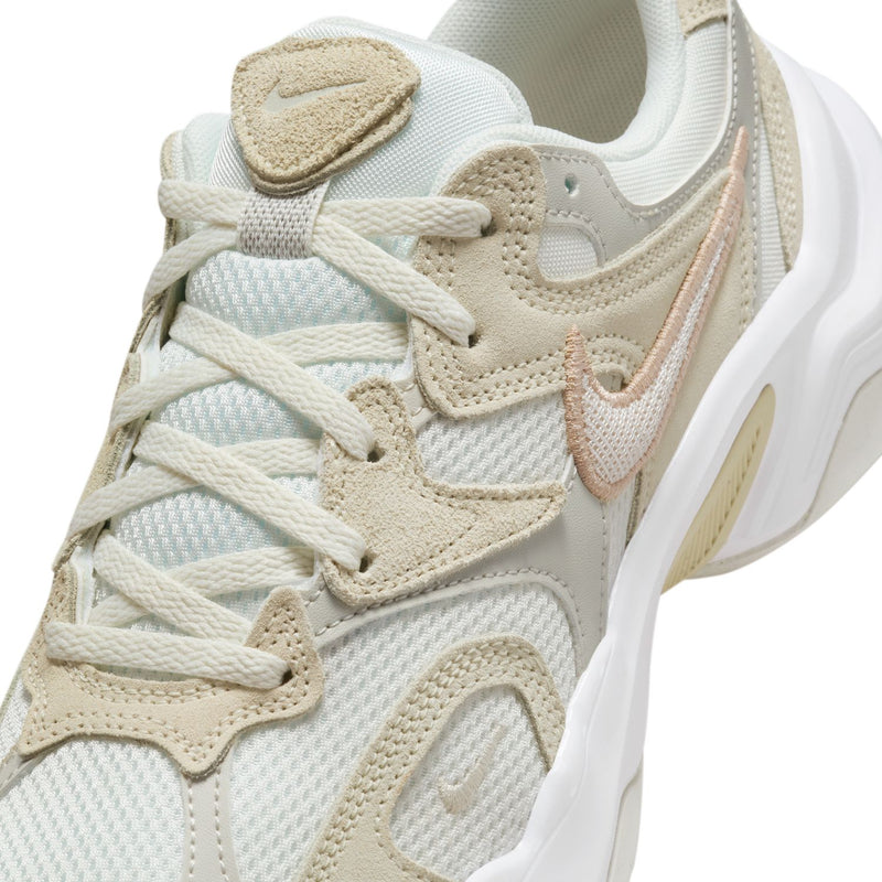 Light bone sneaker upper close-up with laces, mesh panels, and cushioned collar